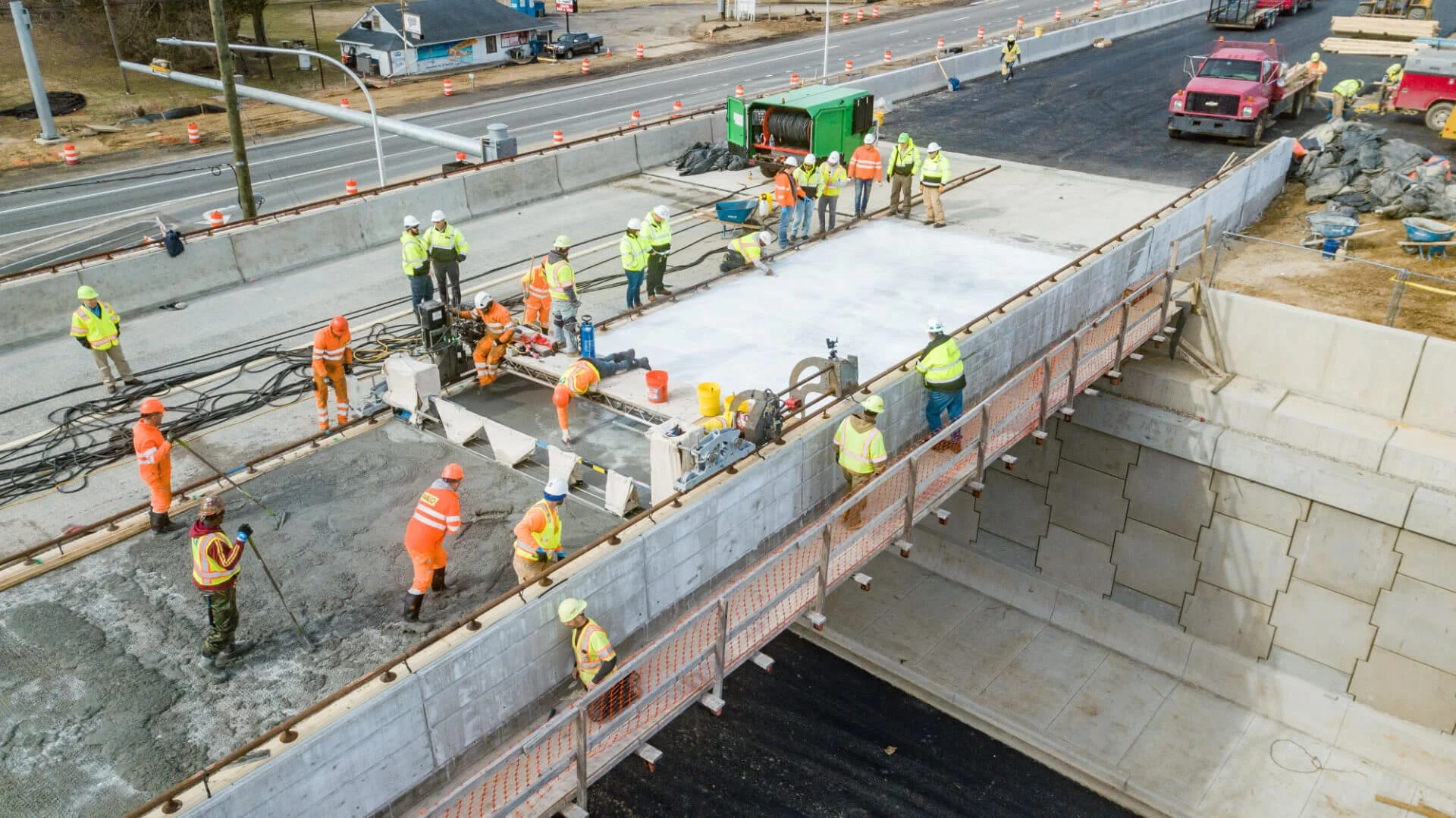 Crew finishing a freshly poured highway bridge deck